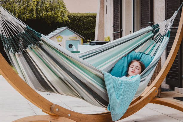 person lying diagonally in wide double hammock with extra fabric space luxury comfort