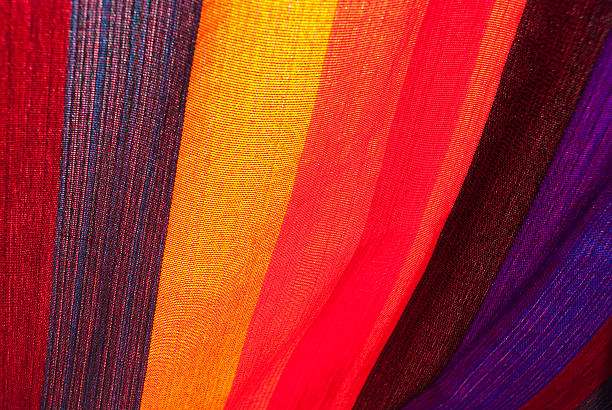 Close-up vibrant striped fabric, colorful textile texture, similar to a hammock.