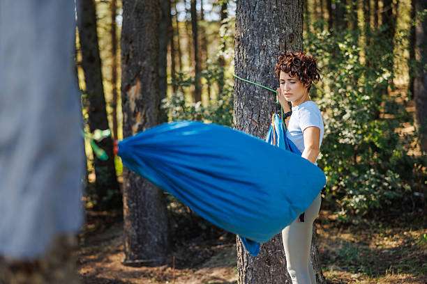 stuffing lightweight nylon hammock into small drawstring bag quick packing